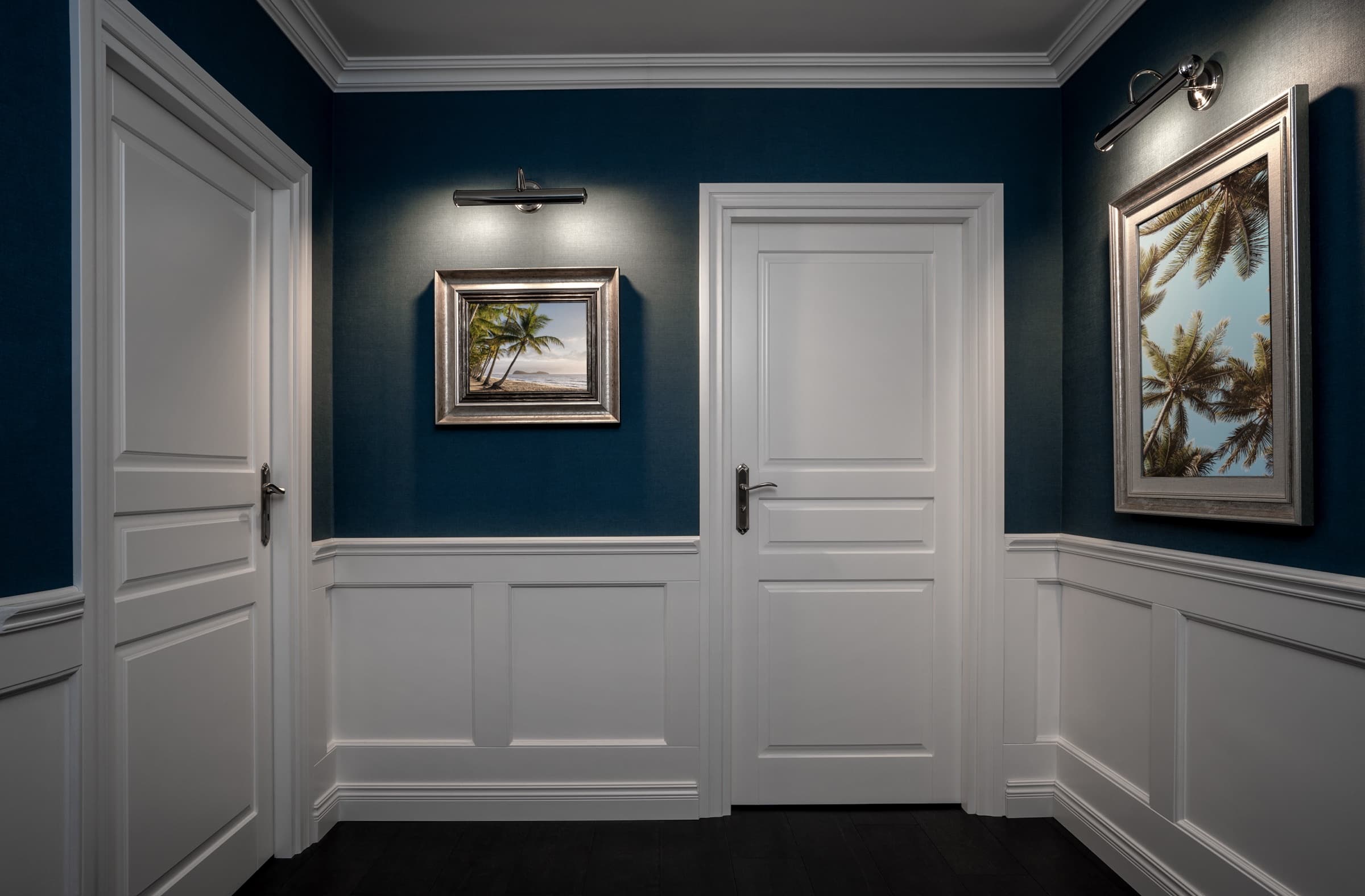 Wainscoting and crown moulding in a navy hallway